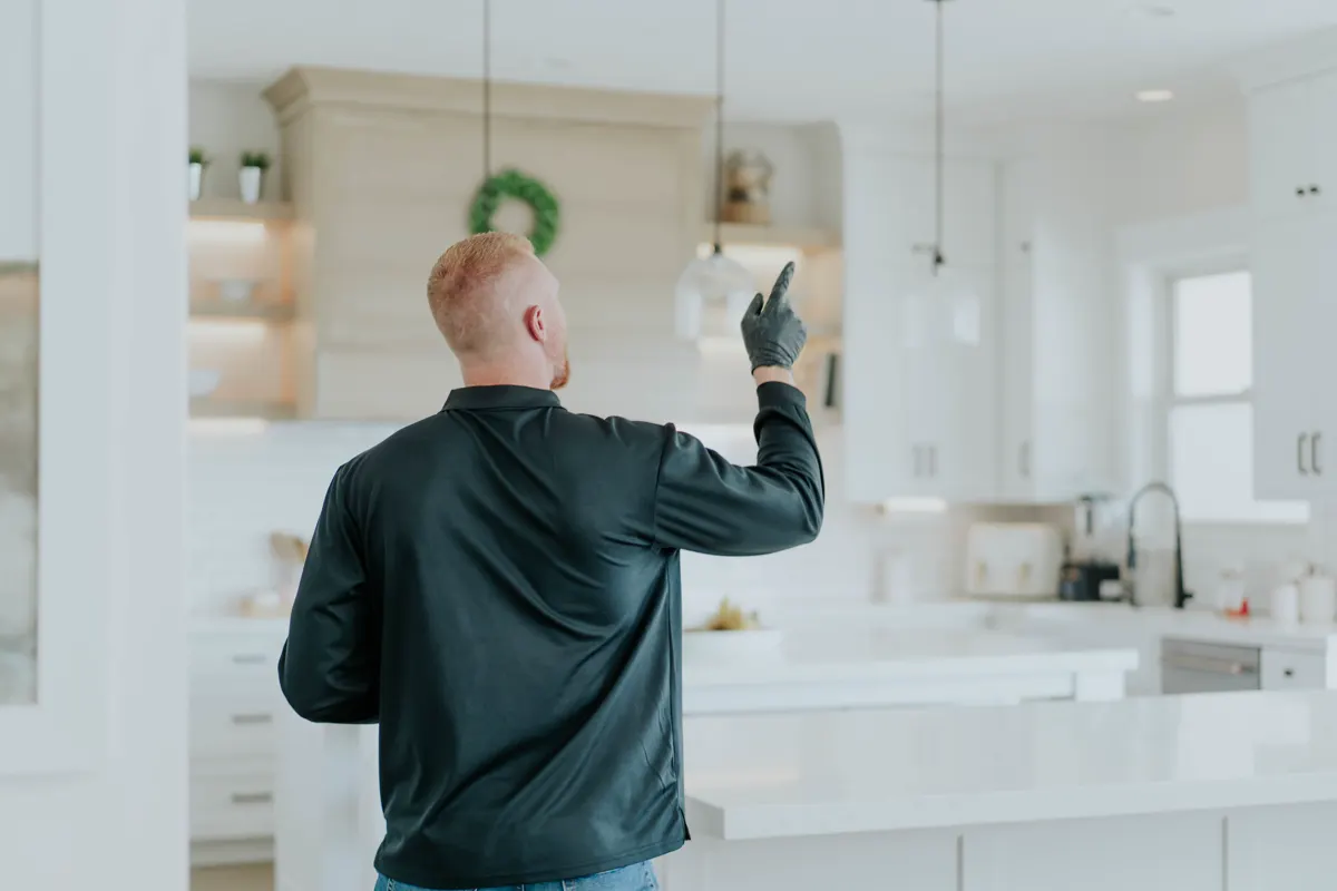 Technician pointing out treated areas during a post-treatment walkthrough